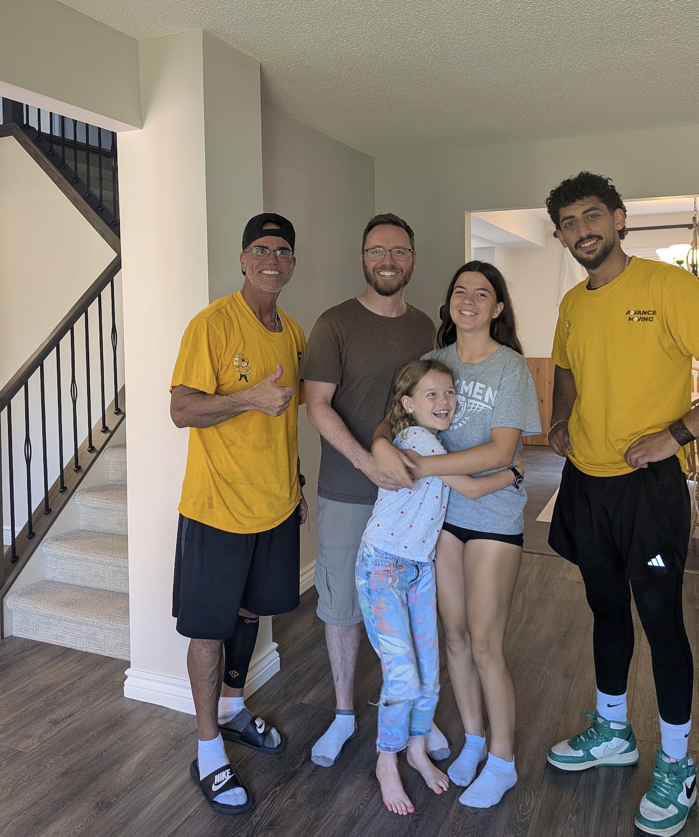 Moving crew finishing a job with a family