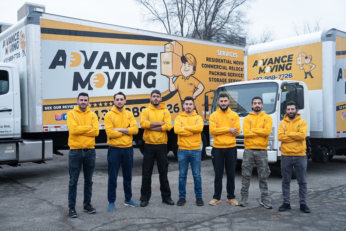 Advance Moving crew in front of two trucks
