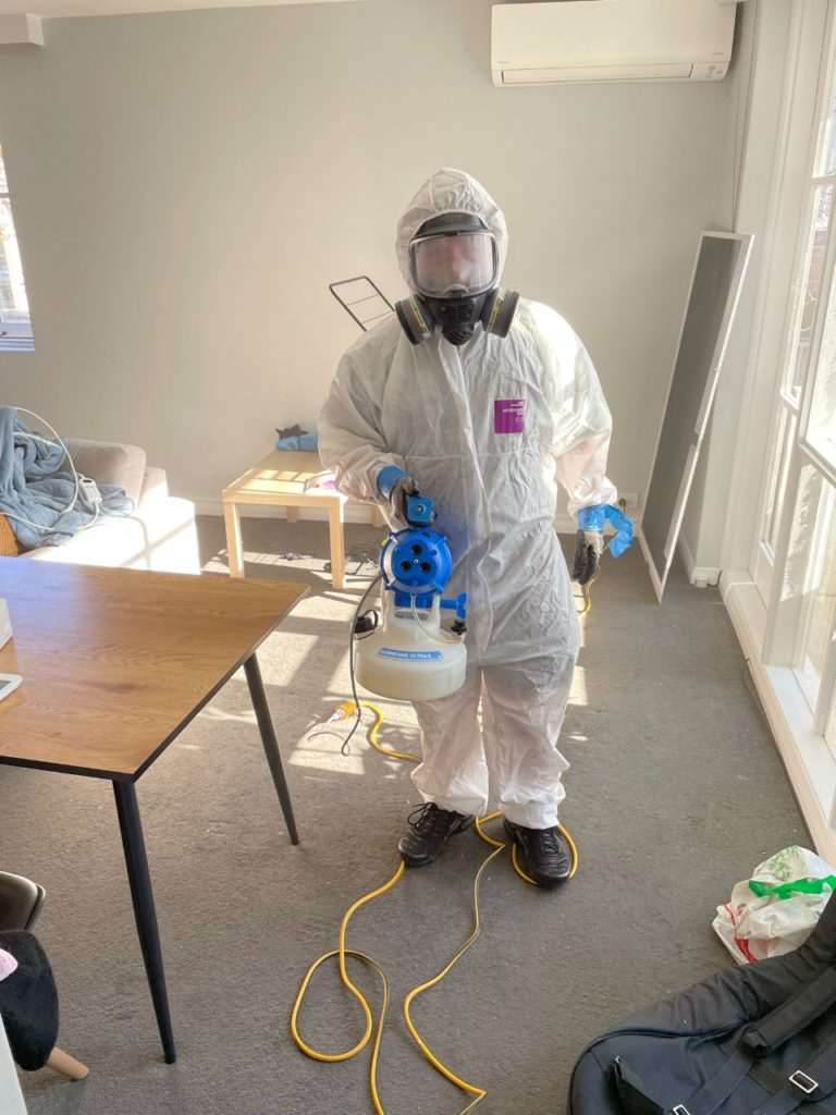 Technician in a suit and respirator on a remediation job